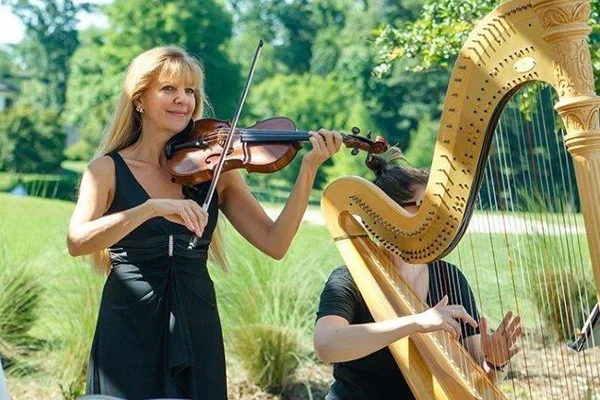 Christine playing violin with harpist