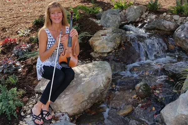Christine sitting on rock